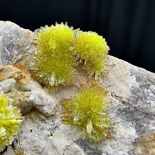 Lime-green creedite needle balls on pale matrix from Guizhou, China, second angle