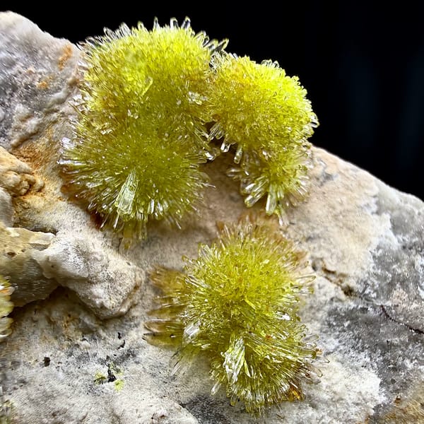 Lime-green creedite needle balls on pale matrix from Guizhou, China, reverse side