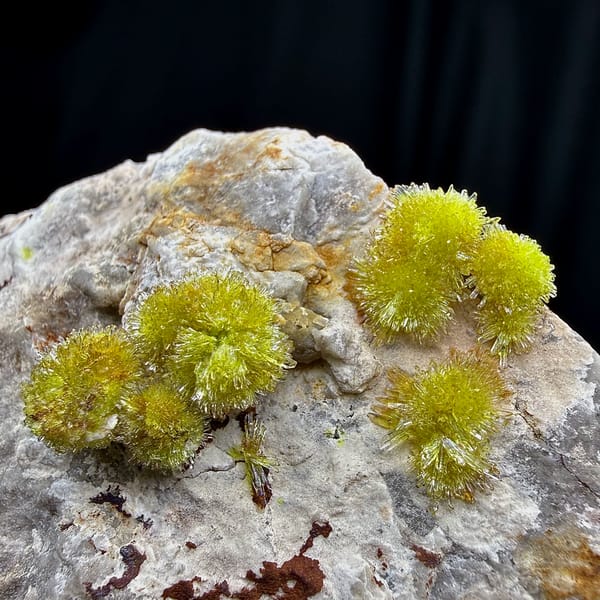 Lime-green creedite needle balls on pale matrix from Guizhou, China, top view
