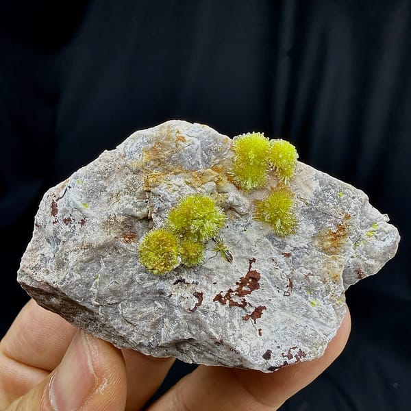 Lime-green creedite needle balls on pale matrix from Guizhou, China, detail of the matrix contact