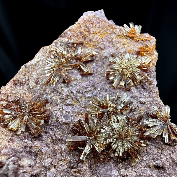 Creedite chrysanthemum sprays on lavender fluorite from Guizhou, China, close-up of the crystal faces