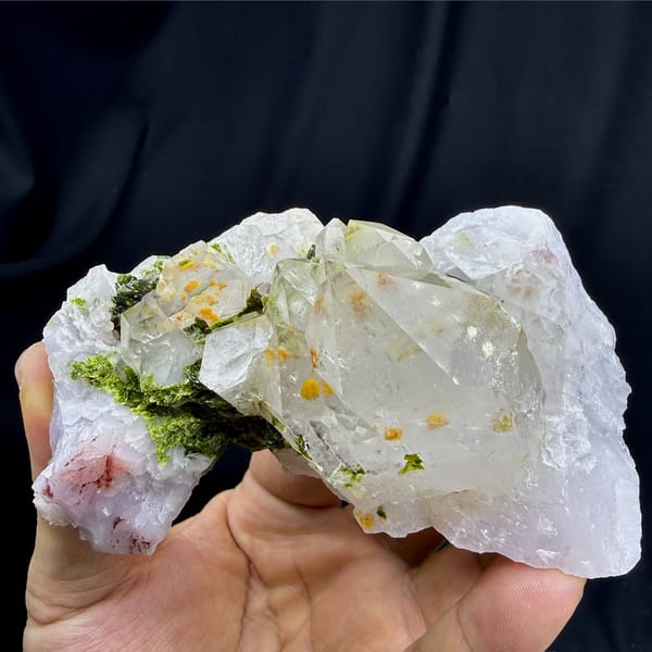 Milky garden quartz crystals with green epidote from Sichuan, China, detail of the matrix contact