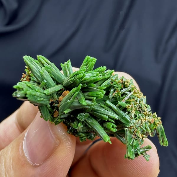 Thicket of grass-green pyromorphite prisms from Guangxi, China, held in hand