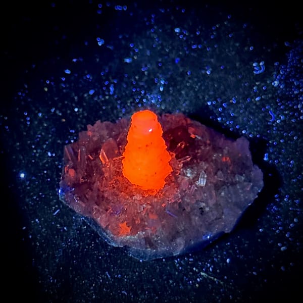 Stacked coin-shaped calcite tower on clear quartz needles from Fujian, China, second angle