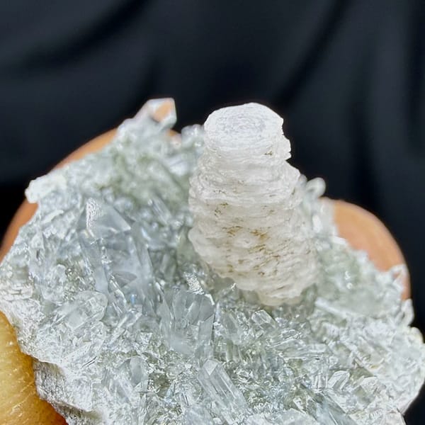 Stacked coin-shaped calcite tower on clear quartz needles from Fujian, China, top view