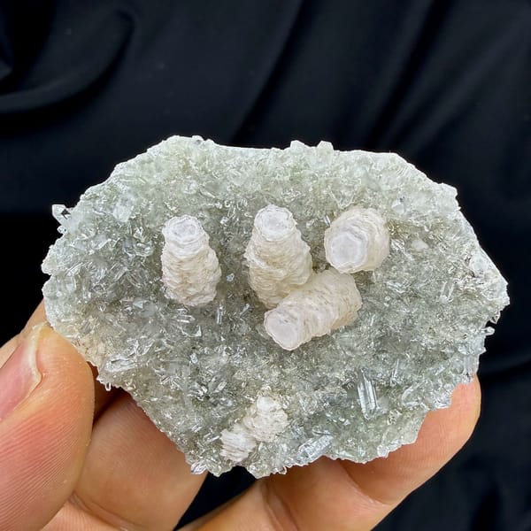Three stacked pagoda calcite towers on quartz needles from Fujian, China, close-up of the crystal faces