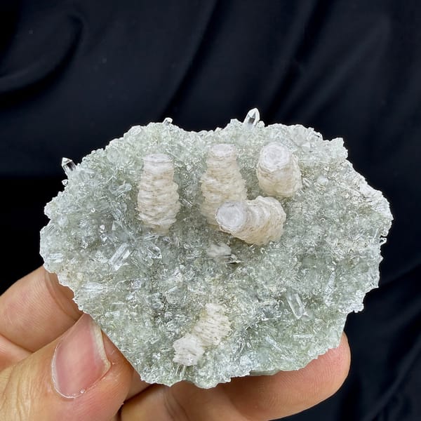 Three stacked pagoda calcite towers on quartz needles from Fujian, China, detail of the matrix contact