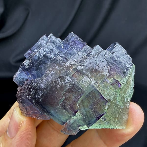 Stepped blue fluorite overgrowing green octahedral fluorite from Jiangxi, China, close-up of the crystal faces