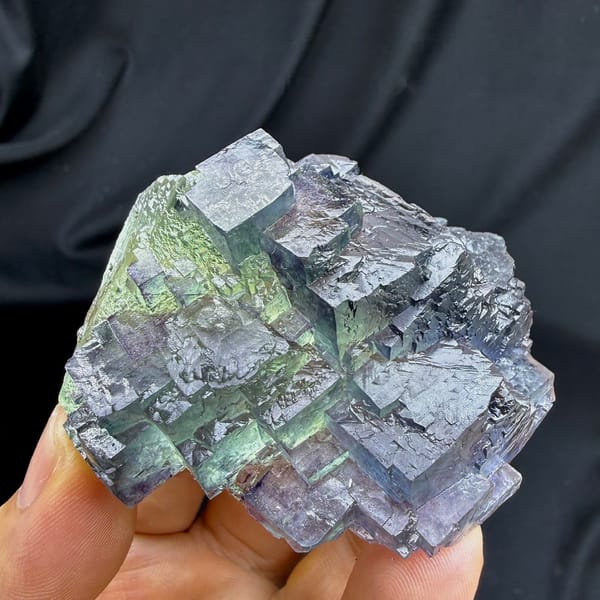 Stepped blue fluorite overgrowing green octahedral fluorite from Jiangxi, China, detail of the matrix contact