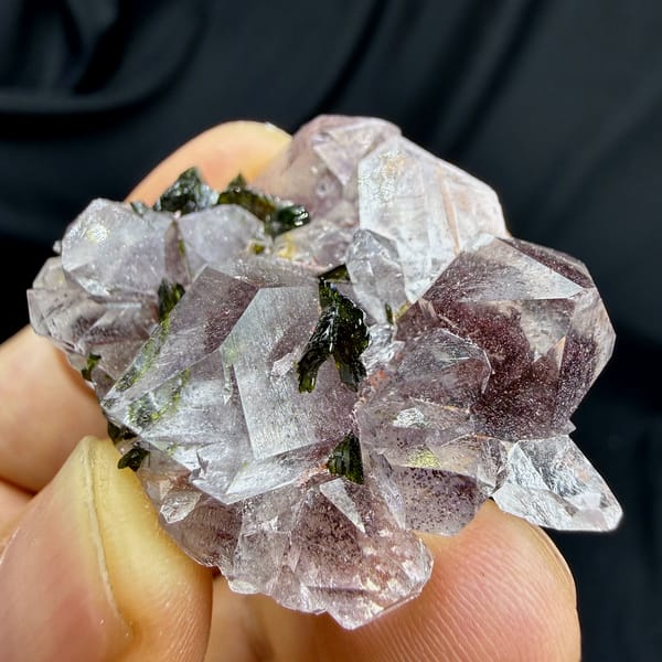 Strawberry-pink garden quartz crystals with green epidote from Sichuan, China, close-up of the crystal faces
