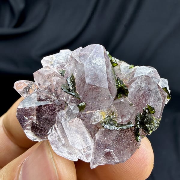 Strawberry-pink garden quartz crystals with green epidote from Sichuan, China, detail of the matrix contact