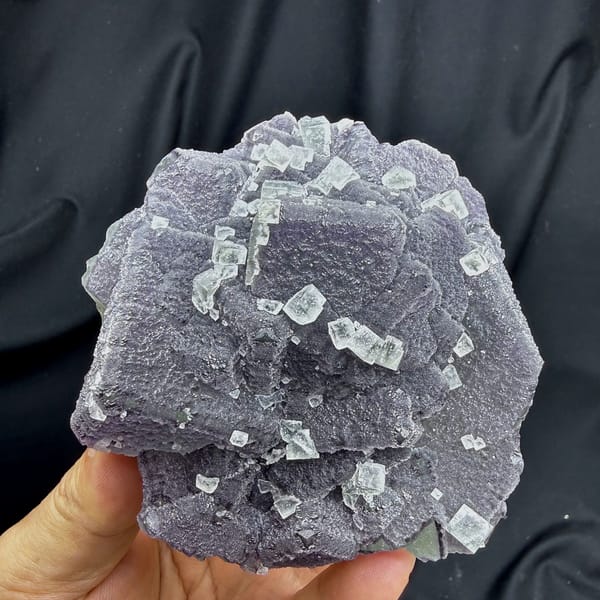 Muted lavender recrystallised fluorite with small green cubes from Fujian, China, reverse side
