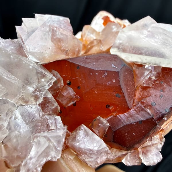 Red-skinned calcite core inside clear calcite crystals from Fujian, China, second angle
