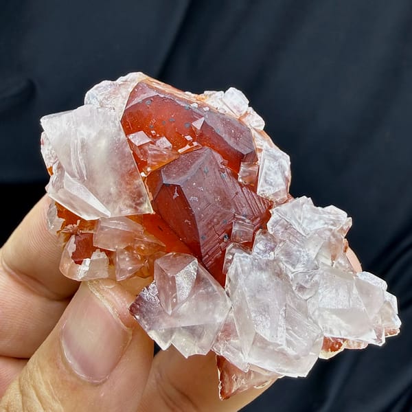Red-skinned calcite core inside clear calcite crystals from Fujian, China, close-up of the crystal faces