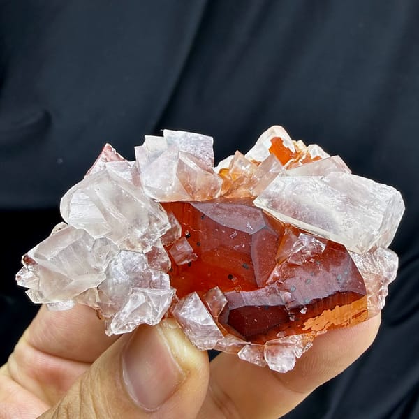 Red-skinned calcite core inside clear calcite crystals from Fujian, China, reverse side