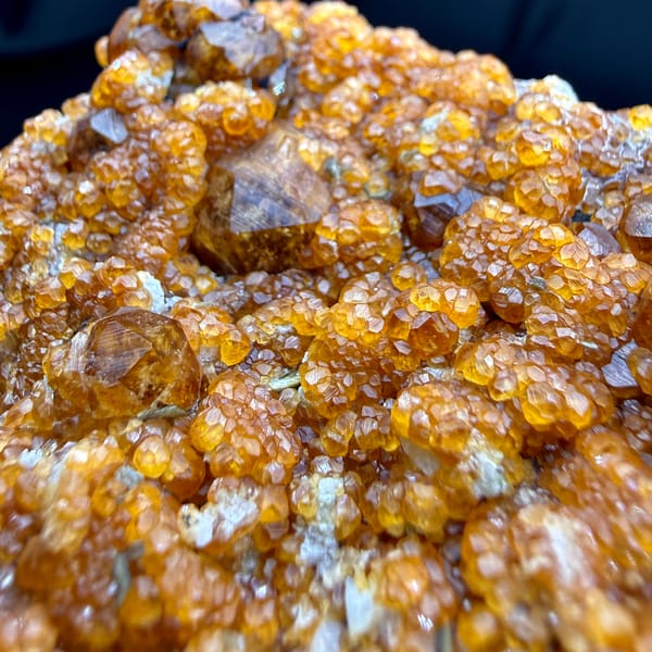 Plate crusted with Fanta-orange spessartine garnets from Yunxiao, Fujian, China, top view