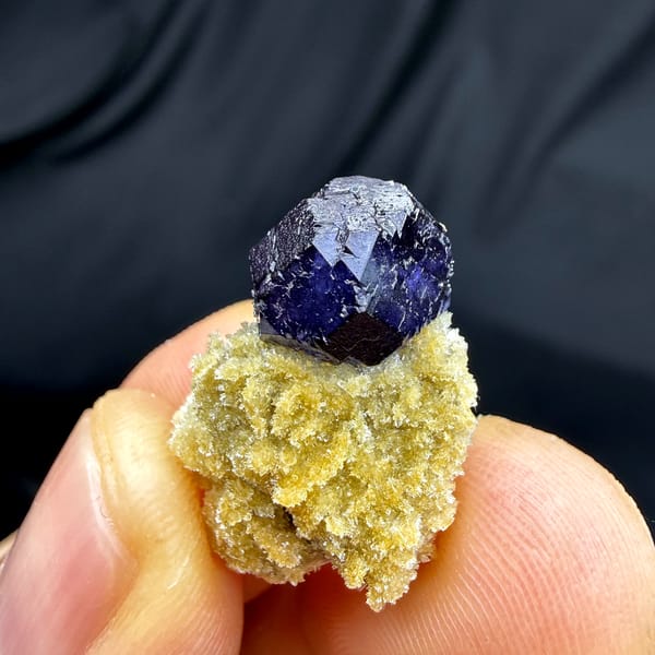 Deep blue fluorite octahedron on pale zeolite pedestal from Yunxiao, Fujian, China, close-up of the crystal faces