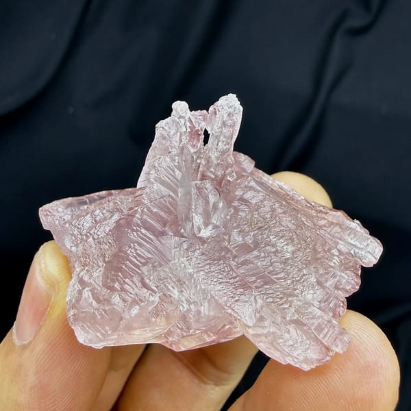Pink lingzhi-mushroom shaped calcite floater from Guangdong, China, close-up of the crystal faces