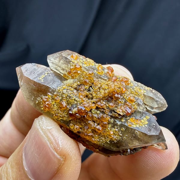 Smoky double-terminated quartz with orange spessartine garnets from Yunxiao, Fujian, China, reverse side