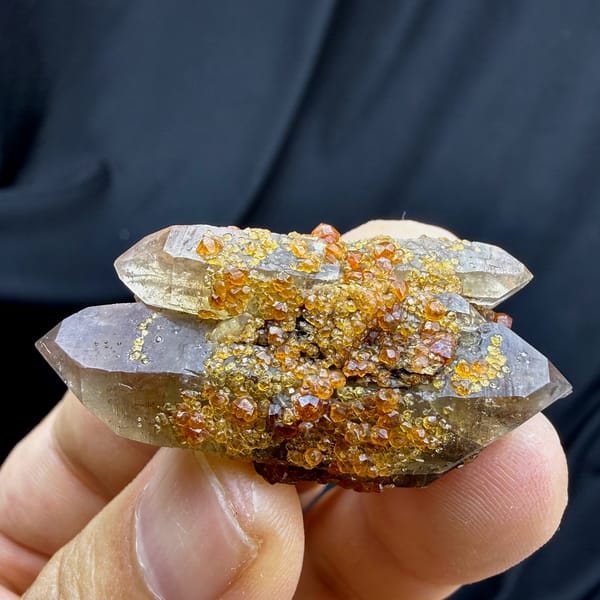 Smoky double-terminated quartz with orange spessartine garnets from Yunxiao, Fujian, China, top view