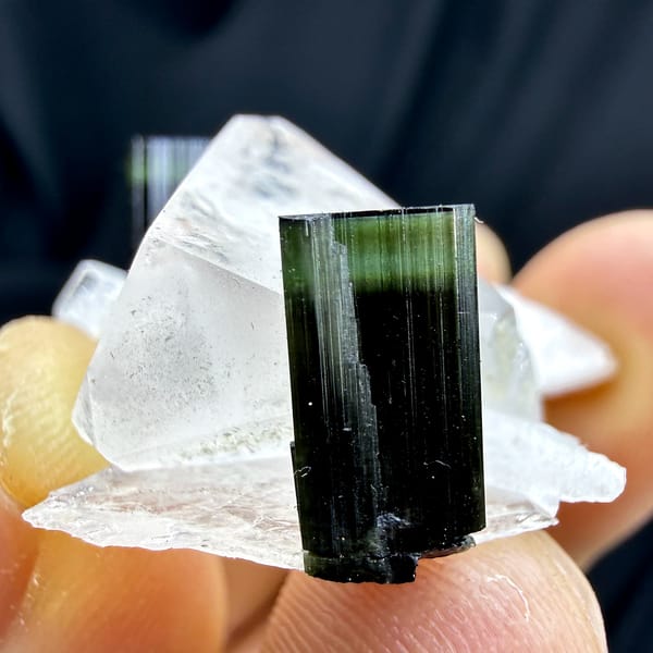 Clear quartz crystal with green-tipped black tourmaline and feldspar from Pakistan, second angle
