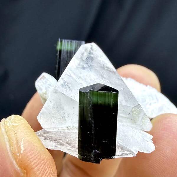 Clear quartz crystal with green-tipped black tourmaline and feldspar from Pakistan, close-up of the crystal faces