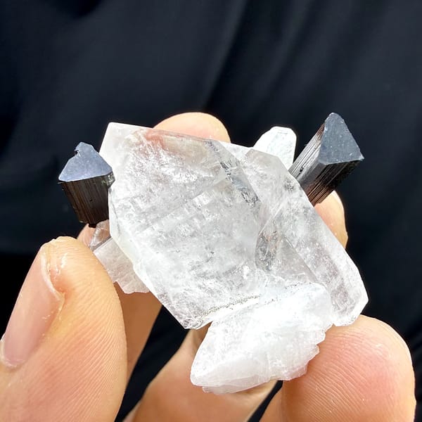 Clear quartz crystal with green-tipped black tourmaline and feldspar from Pakistan, top view