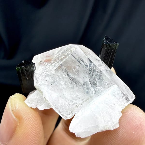 Clear quartz crystal with green-tipped black tourmaline and feldspar from Pakistan, detail of the matrix contact