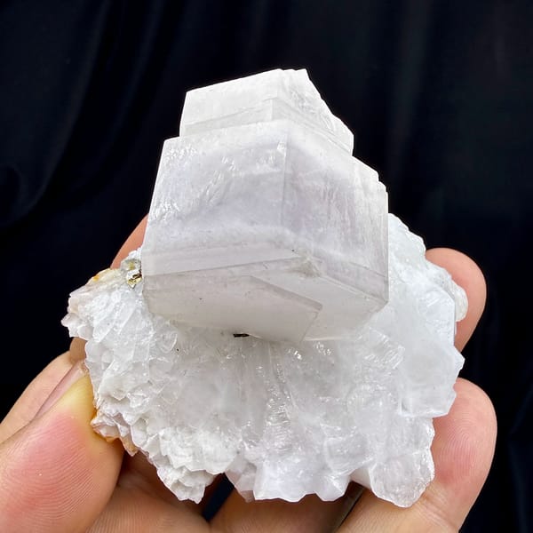Pale pink hexagonal calcite crystal on white quartz from Fujian, China, top view