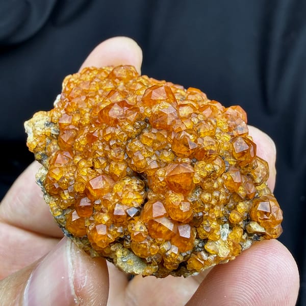 Plate of Fanta-orange spessartine garnet crystals from Yunxiao, Fujian, China, close-up of the crystal faces