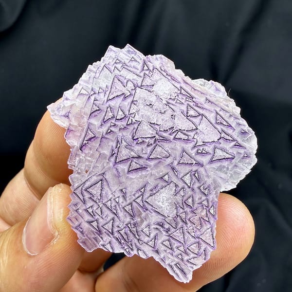 Lavender fluorite plate with purple triangular etch patterns from Yunnan, China, close-up of the crystal faces