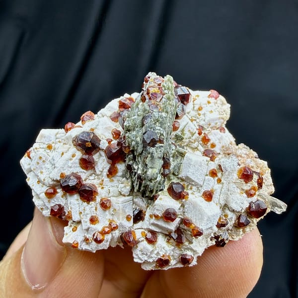 Dark-red garnets with mica and hyalite opal on feldspar from Yunxiao, Fujian, China