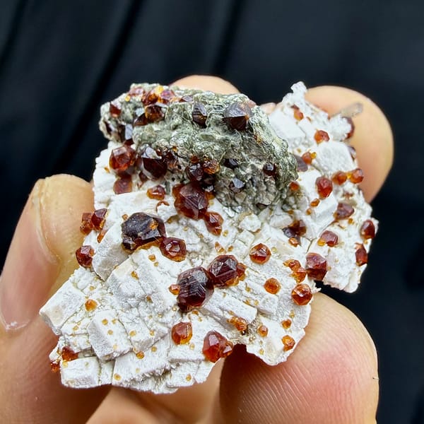 Dark-red garnets with mica and hyalite opal on feldspar from Yunxiao, Fujian, China, reverse side