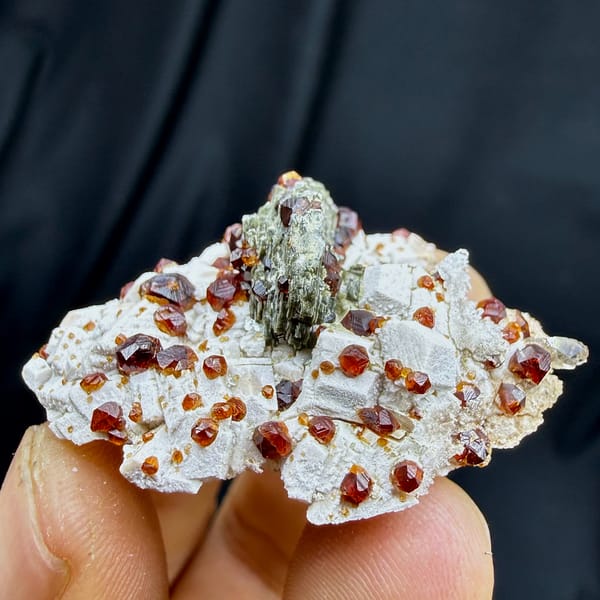 Dark-red garnets with mica and hyalite opal on feldspar from Yunxiao, Fujian, China, top view