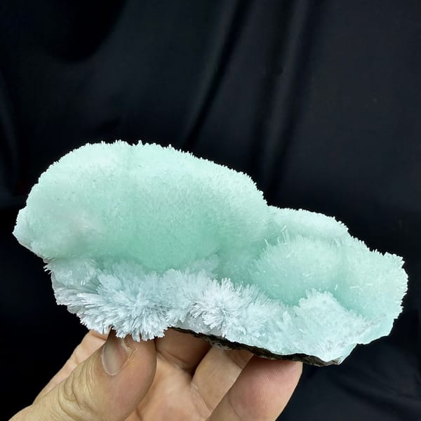 Aqua-blue acicular aragonite flower mounds from Yunnan, China, detail of the matrix contact