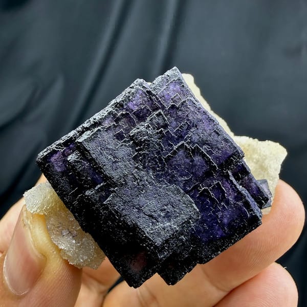 Deep violet fluorite cube with phantom zoning on quartz from Inner Mongolia, China