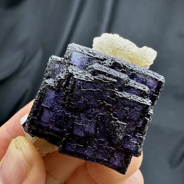 Deep violet fluorite cube with phantom zoning on quartz from Inner Mongolia, China, close-up of the crystal faces