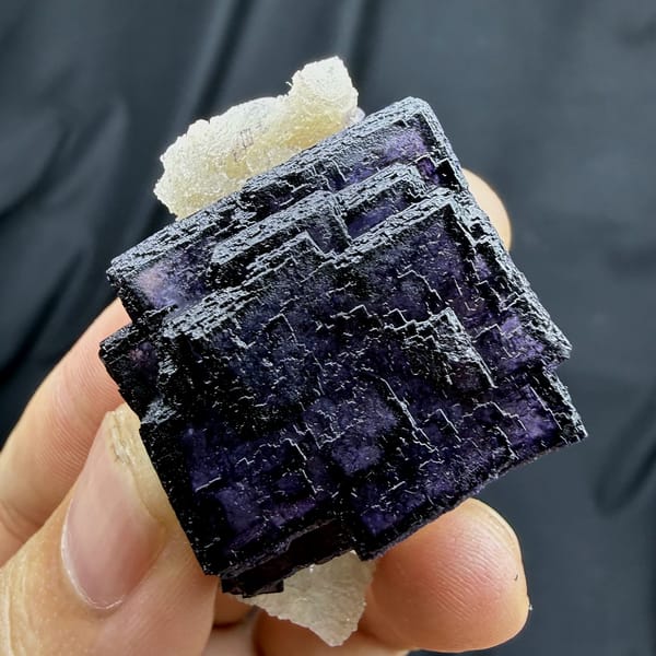 Deep violet fluorite cube with phantom zoning on quartz from Inner Mongolia, China, reverse side