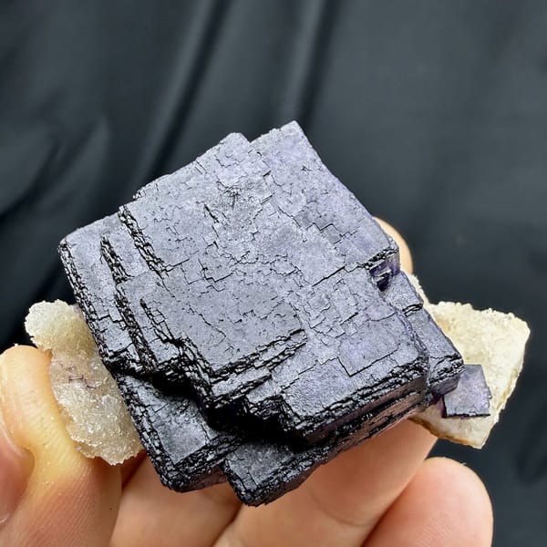 Deep violet fluorite cube with phantom zoning on quartz from Inner Mongolia, China, top view
