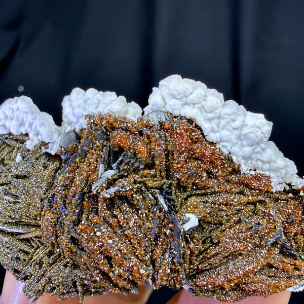 Red vanadinite on brown baryte with white aragonite from Morocco, second angle