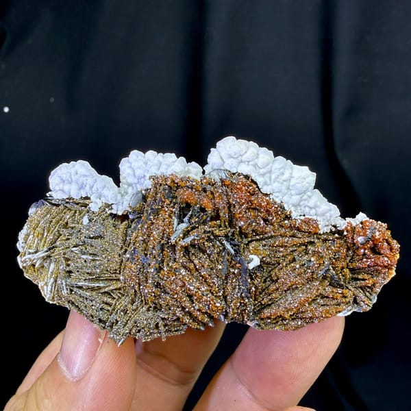 Red vanadinite on brown baryte with white aragonite from Morocco, detail of the matrix contact