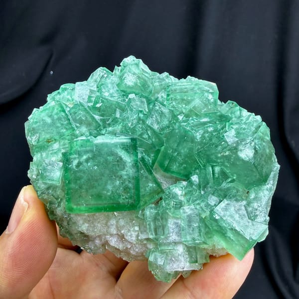 Sea-green daylight fluorite cubes on white quartz from Madagascar, reverse side