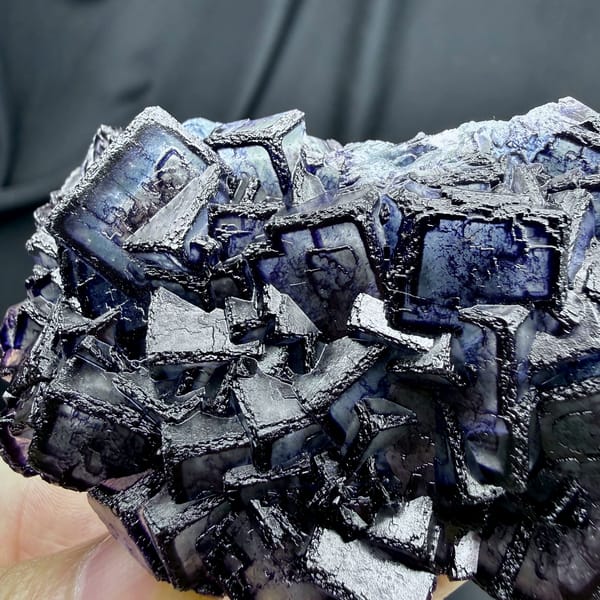 Inky blue fluorite cubes with purple rims from Inner Mongolia, China, close-up of the crystal faces