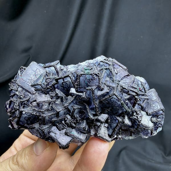 Inky blue fluorite cubes with purple rims from Inner Mongolia, China, detail of the matrix contact
