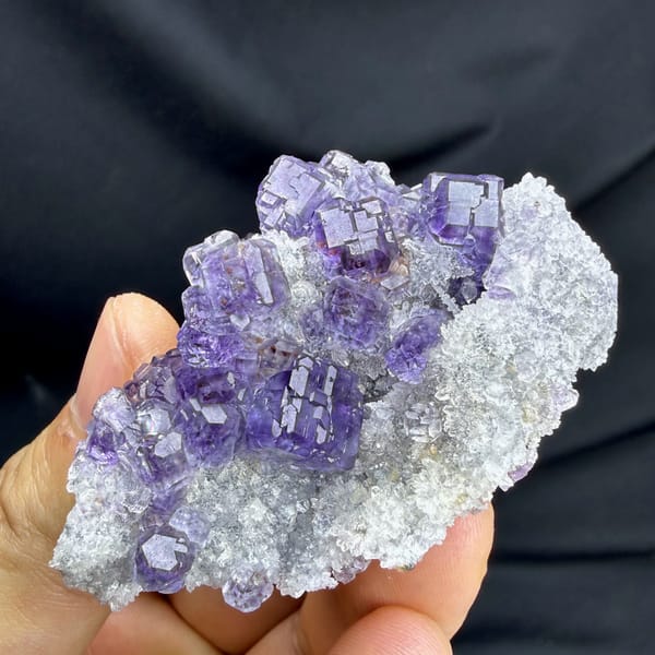 Violet-blue fluorite cubes on white quartz from Fujian, China, close-up of the crystal faces