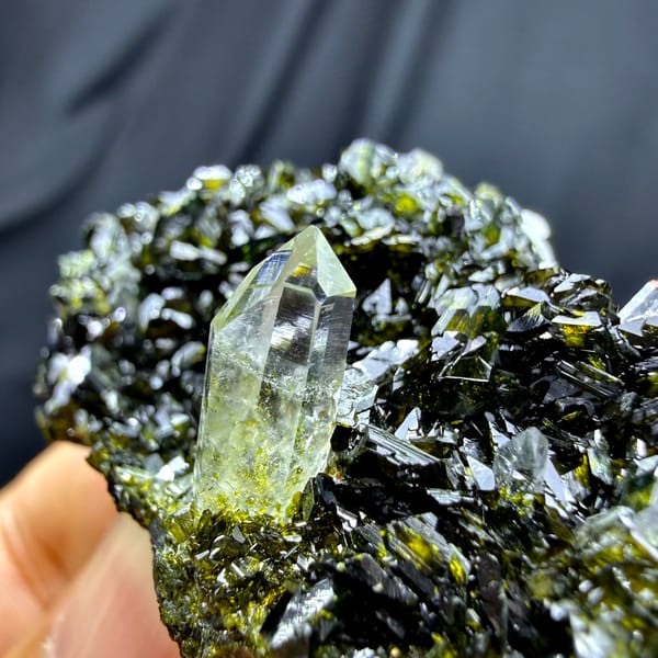 Clear quartz point standing in dark green epidote from Sichuan, China, second angle