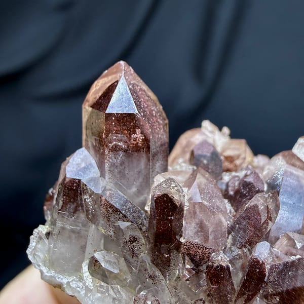 Row of clear quartz points with red hematite phantoms from Shanxi, China, second angle