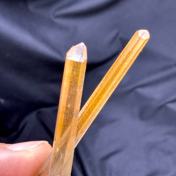 Two orange hematoid quartz needles on specular hematite from Guangdong, China, second angle