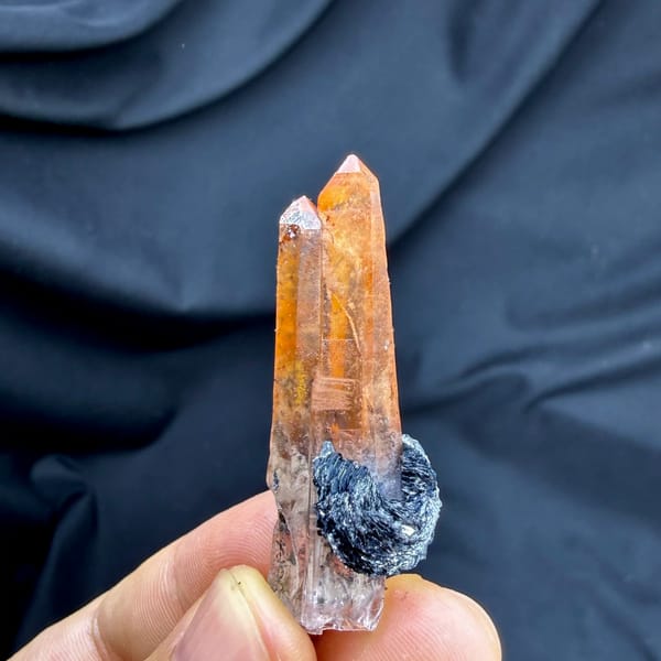 Flame-orange hematoid quartz crystal on black specular hematite from Guangdong, China, reverse side
