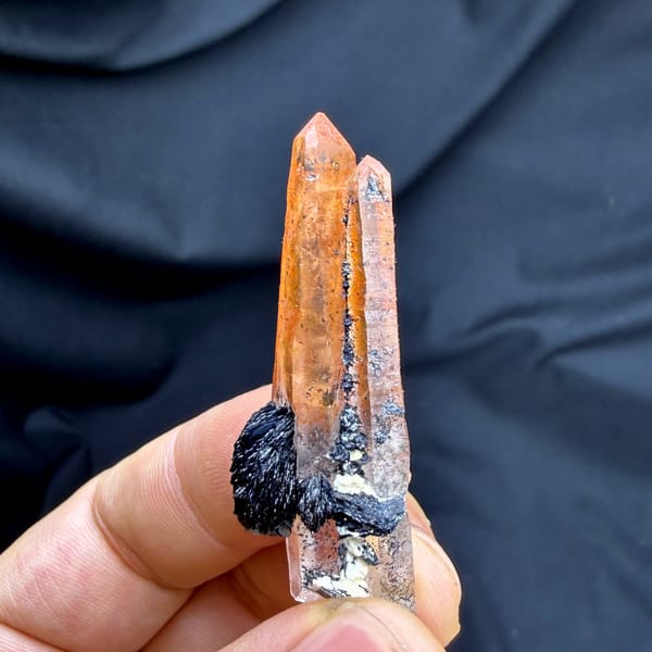 Flame-orange hematoid quartz crystal on black specular hematite from Guangdong, China, top view